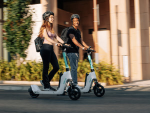 Two Beryl e-scooters being ridden
