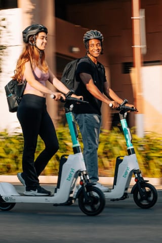 Two Beryl e-scooters being ridden