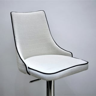 An empty grey chair with dark trim sits in front of a grey background