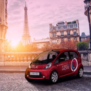 Free2Move car in Paris with Eiffel Tower in the background