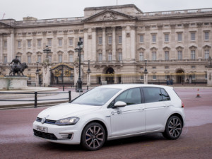 Electric car club vehicle passing in front of Buckingham Palace in London