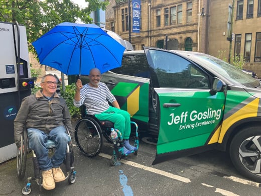 Wheelchair users Dave and Krishna are pictured by the adapted car